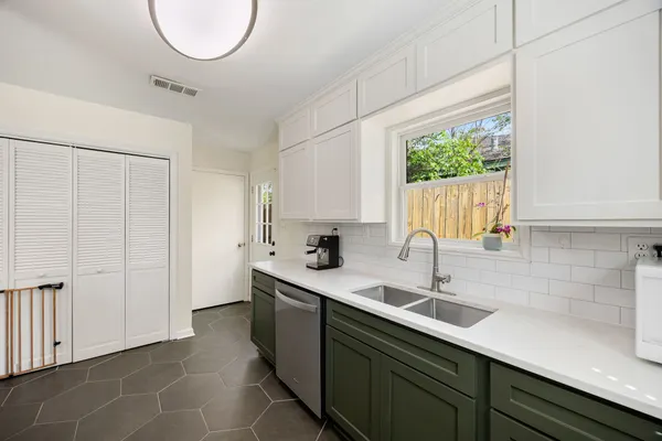 a kitchen with a sink cabinets and a window