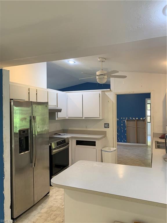 540 2nd Street Southeast Naples, FL 34117 - Photo 13 of 27 a kitchen with stainless steel appliances granite countertop a stove and a refrigerator