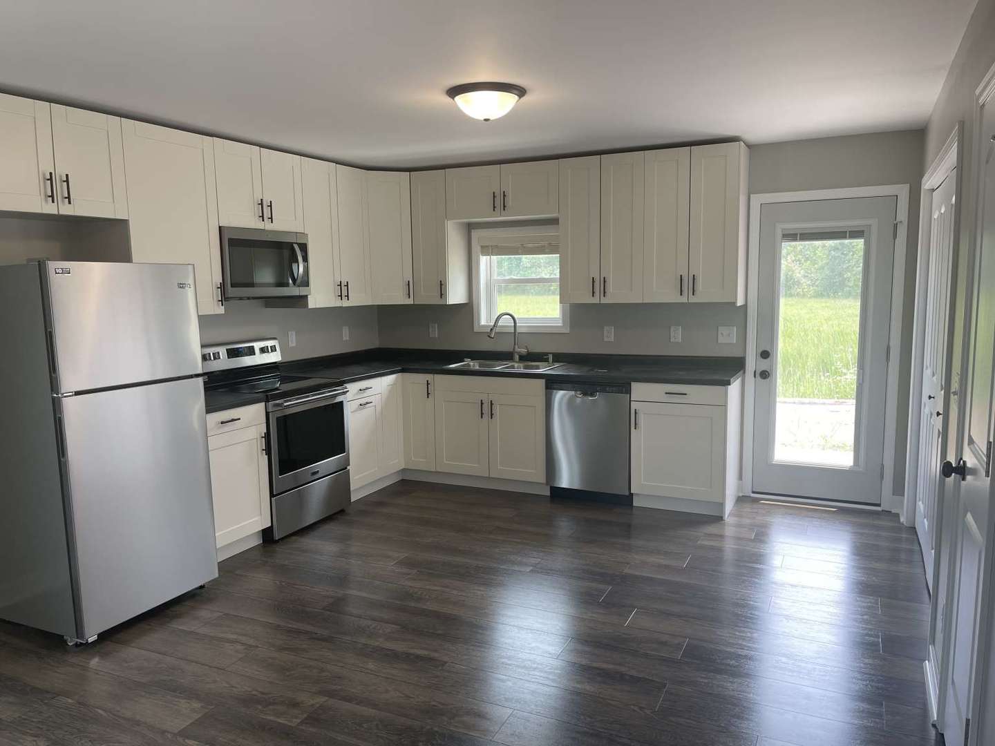 1097 Madison Avenue Braidwood, IL 60408 - Photo 2 of 8 a kitchen with stainless steel appliances granite countertop a stove a sink and white cabinets