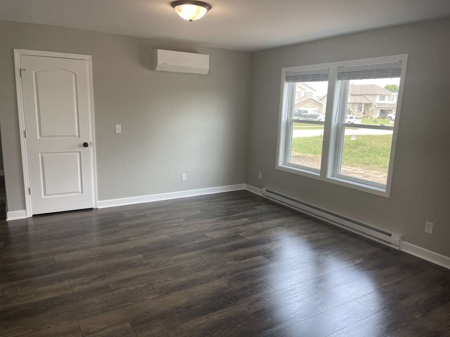 1097 Madison Avenue Braidwood, IL 60408 - Photo 3 of 8 an empty room with wooden floor and windows