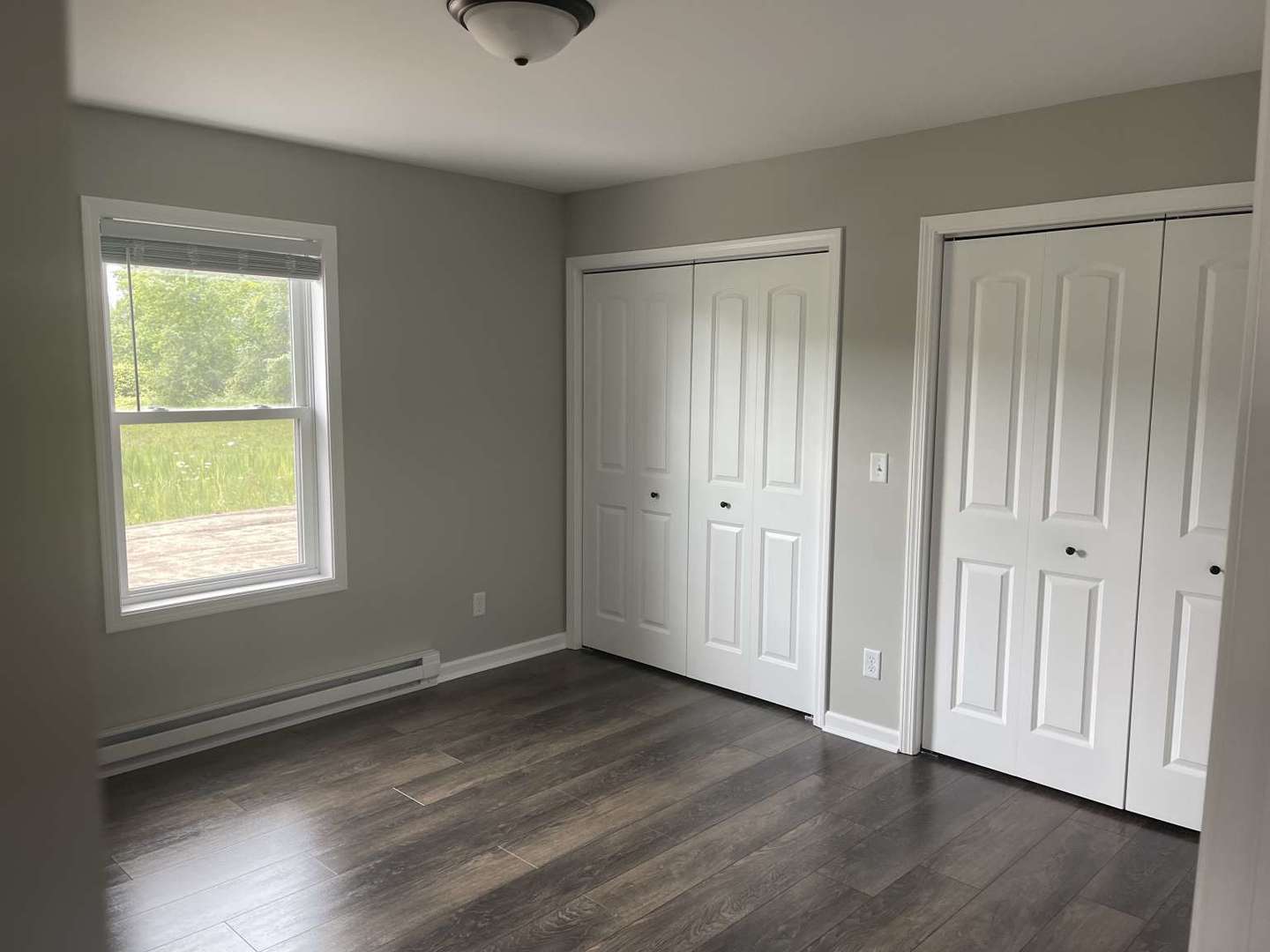 1097 Madison Avenue Braidwood, IL 60408 - Photo 5 of 8 a view of an empty room with wooden floor and a window