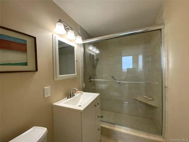 a bathroom with a shower a sink and mirror