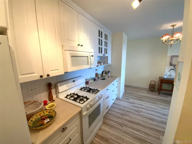 a kitchen with sink stove and refrigerator
