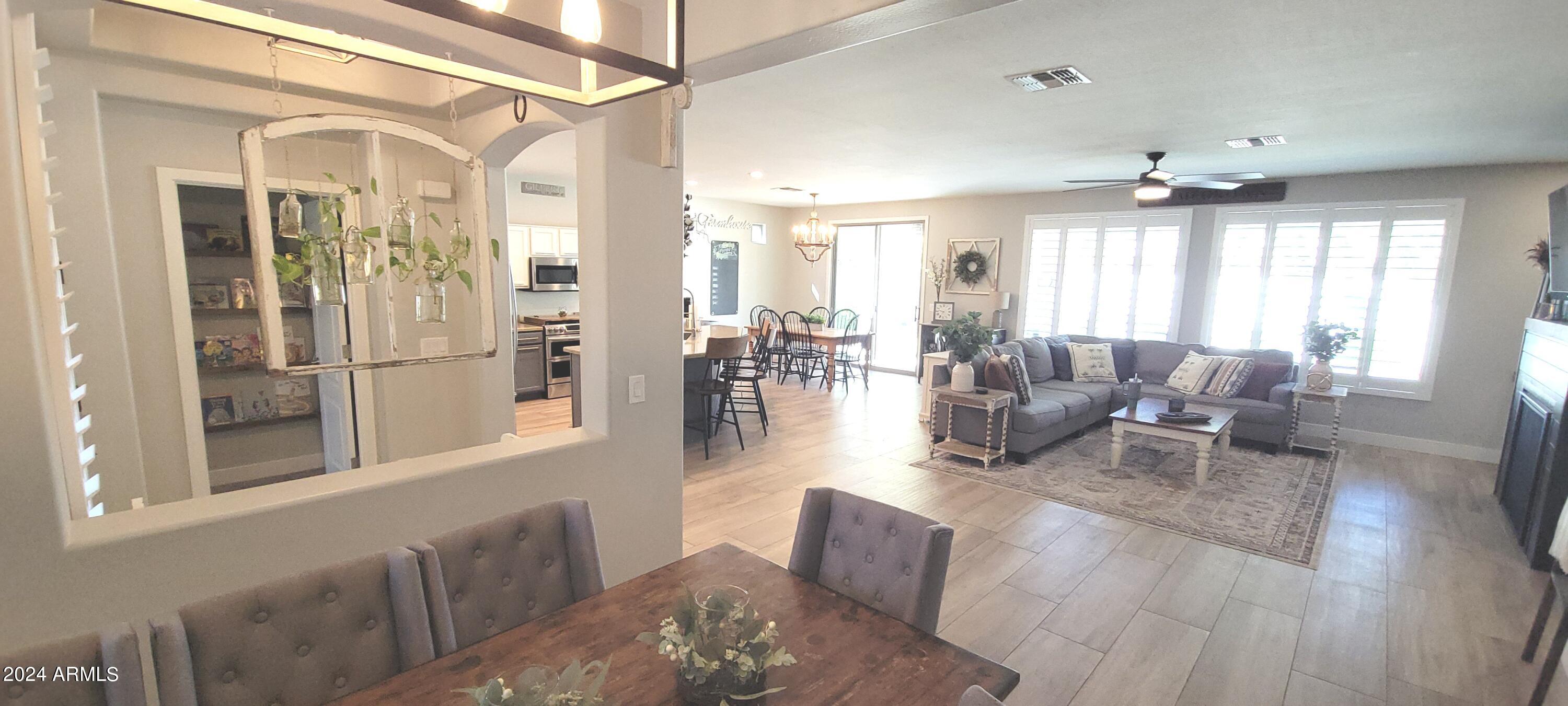 3236 East Phelps Street Gilbert, AZ 85295 - Photo 17 of 50 a living room with furniture and a chandelier