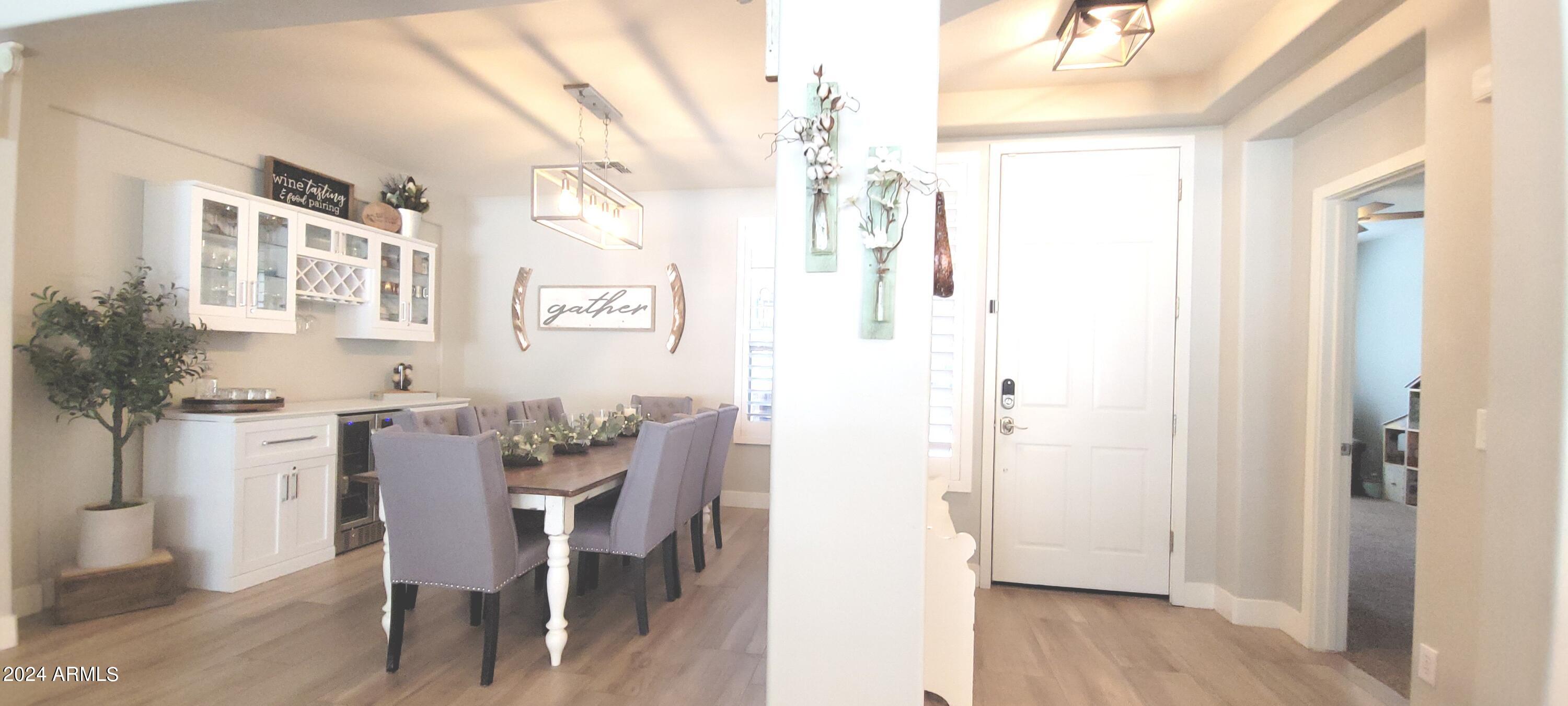 3236 East Phelps Street Gilbert, AZ 85295 - Photo 19 of 50 a view of a dining room with furniture and wooden floor