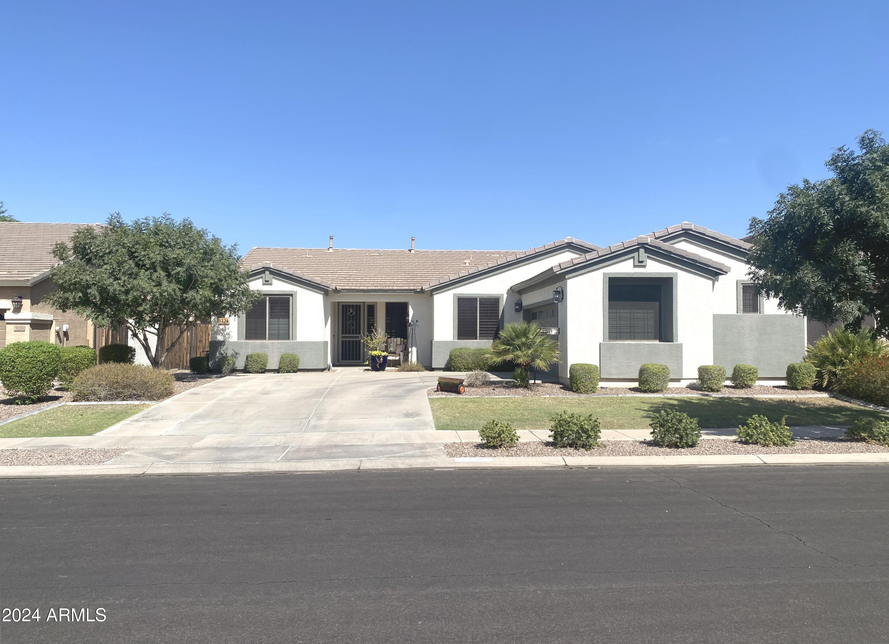 3236 East Phelps Street Gilbert, AZ 85295 - Photo 3 of 50 a front view of house with yard and green space