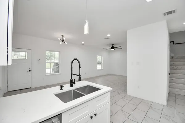 a kitchen with a sink and cabinets