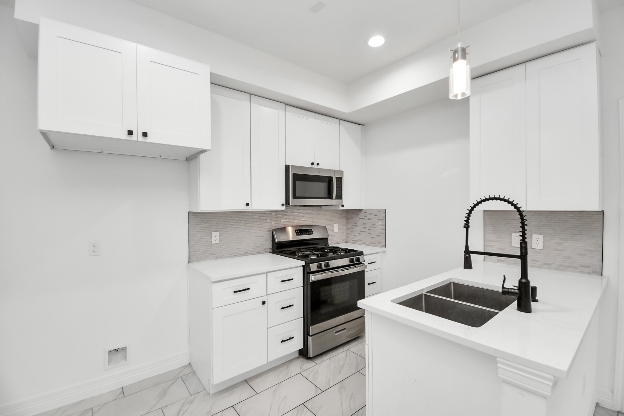 9003 Prairie View Drive, Unit B Houston, TX 77088 - Photo 3 of 20 a kitchen with white cabinets and appliances