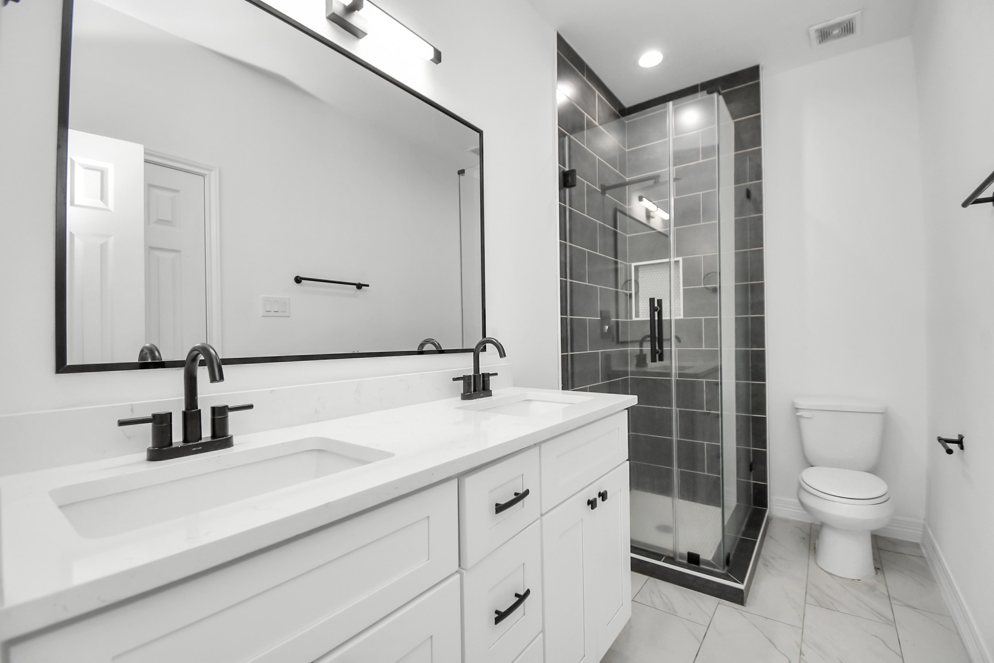 9003 Prairie View Drive, Unit B Houston, TX 77088 - Photo 4 of 20 a bathroom with a double vanity sink toilet and shower