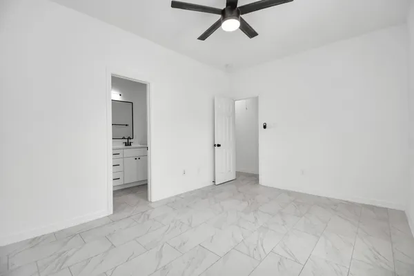 an empty room with closet and windows