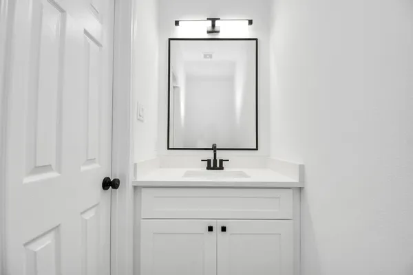 a bathroom with a sink and a mirror