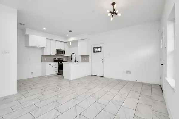 a view of a kitchen with electric appliances