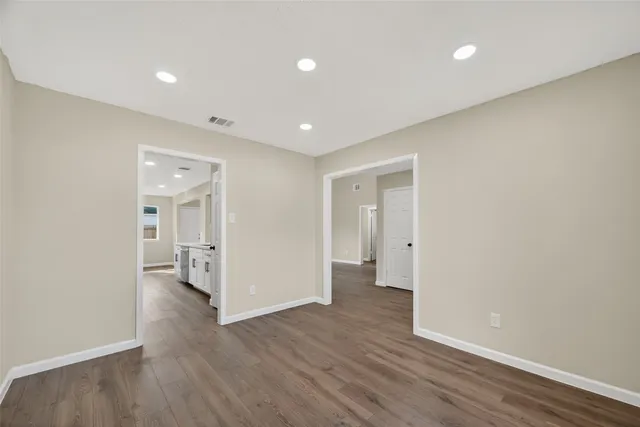 a view of a hallway with wooden floor