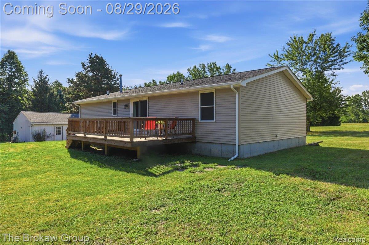 5411 Hess Road Dryden, MI 48428 - Photo 38 of 56 Expansive backyard featuring a wood deck, sliding glass door, and a detached outbuilding