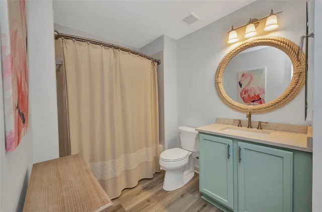 a bathroom with a toilet a sink and a mirror