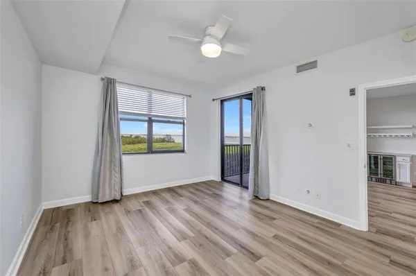 a view of a room with wooden floor and window