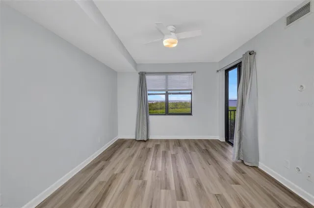 a view of a room with wooden floor and window