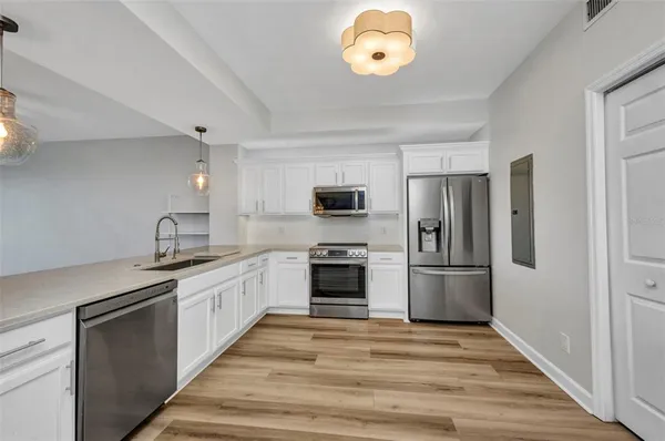a kitchen with a refrigerator and a sink
