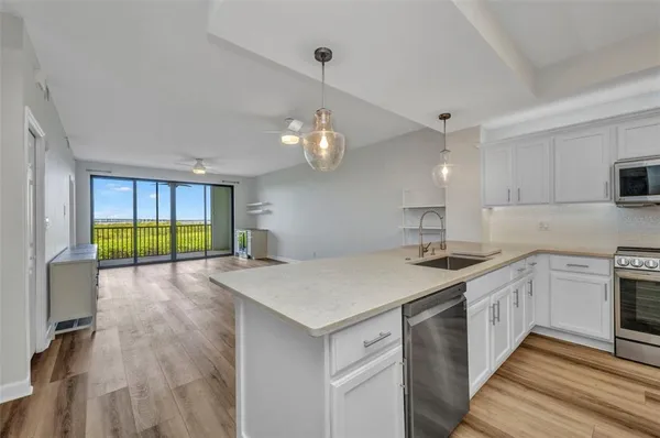 a kitchen with a refrigerator and a stove top oven