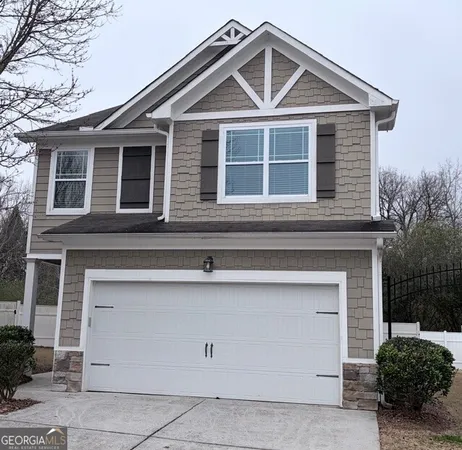 a front view of a house with garage