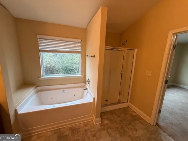 a bathroom with a bathtub and a window