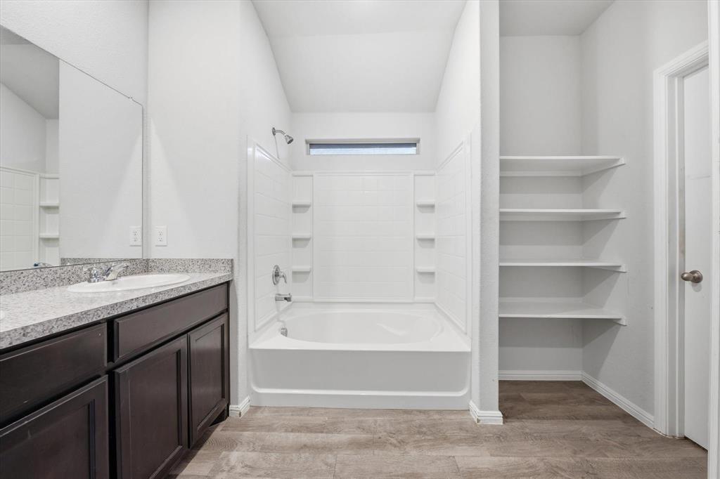 9308 Desertrock Road Fort Worth, TX 76131 - Photo 16 of 29 a bathroom with a bathtub and a sink