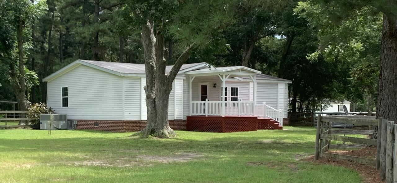 326 Triple T Road Register, GA 30452 - Photo 1 of 1 a front view of house with yard and green space