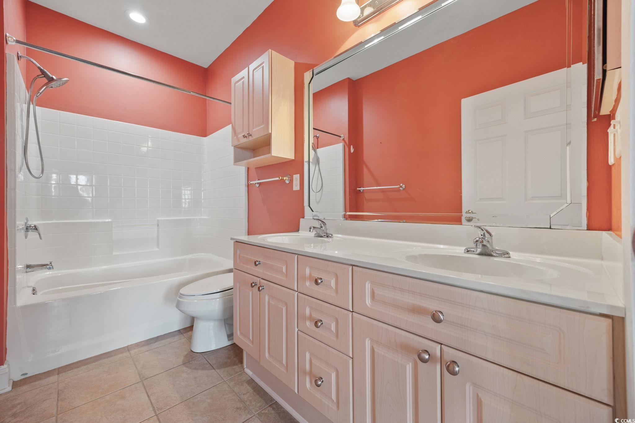 4847 Luster Leaf Circle, Unit 403 Myrtle Beach, SC 29577 - Photo 19 of 37 Full bathroom featuring double vanity, bathing tub / shower combination, and light tile patterned floors