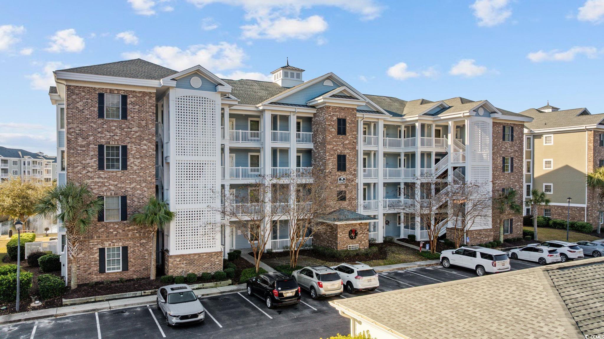 4847 Luster Leaf Circle, Unit 403 Myrtle Beach, SC 29577 - Photo 28 of 37 View of apartment building / complex with uncovered parking