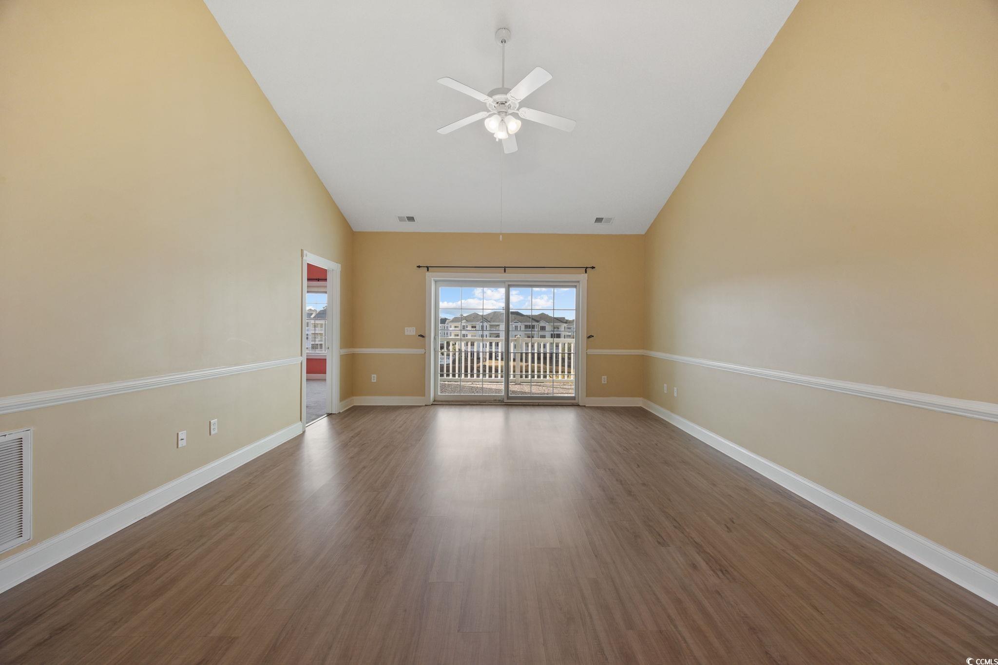 4847 Luster Leaf Circle, Unit 403 Myrtle Beach, SC 29577 - Photo 6 of 37 Spare room featuring wood finished floors, high vaulted ceiling, and a ceiling fan