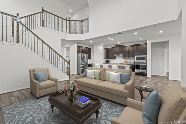 a living room with furniture and kitchen view