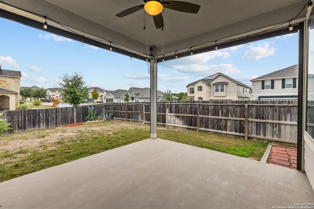 a view of a backyard with wooden fence