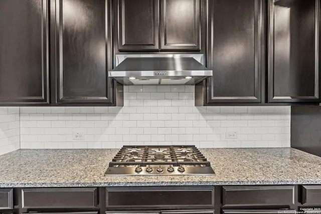 a stove top oven sitting inside of a kitchen
