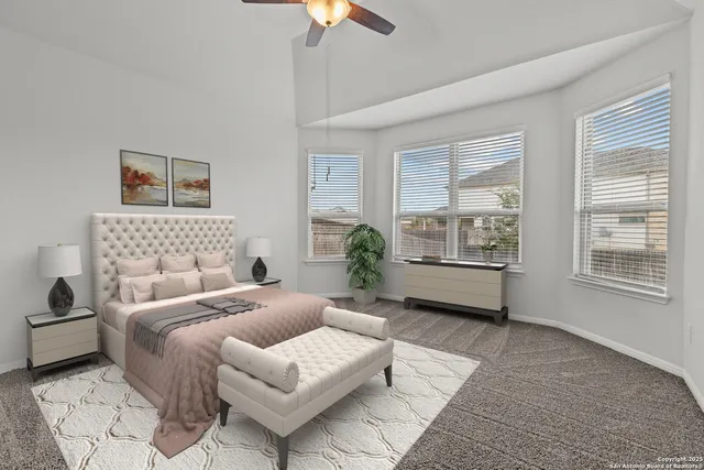 a bedroom with furniture and a large window