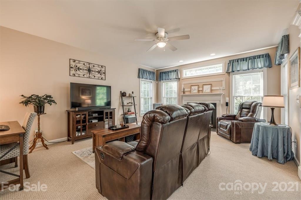 152 Melbourne Drive Fort Mill, SC 29708 - Photo 7 of 32 a living room with furniture a large window and flat screen tv