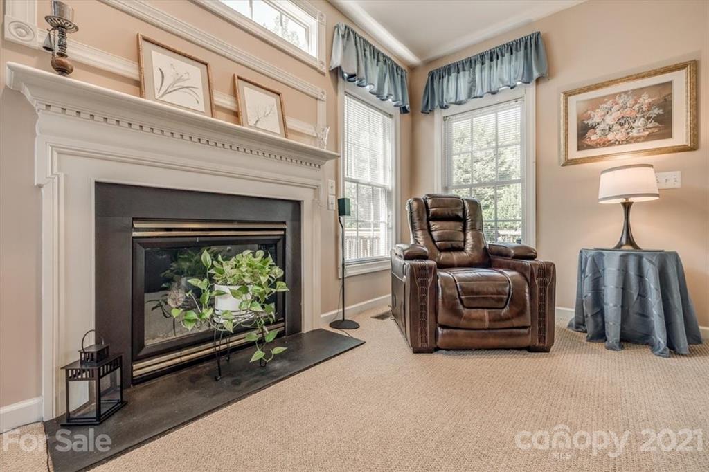 152 Melbourne Drive Fort Mill, SC 29708 - Photo 8 of 32 a living room with furniture a fireplace and a flat screen tv