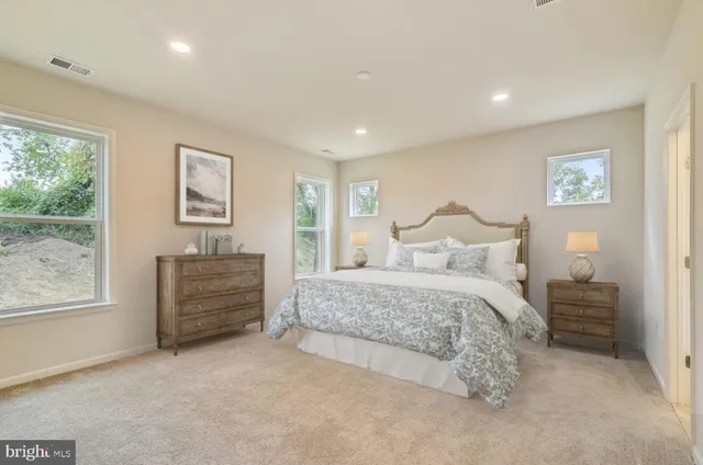 a bedroom with a bed and a night stand