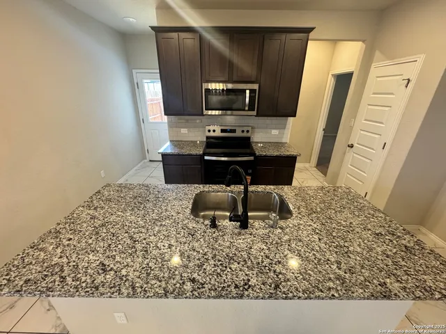 a view of a livingroom with a furniture and a chandelier fan