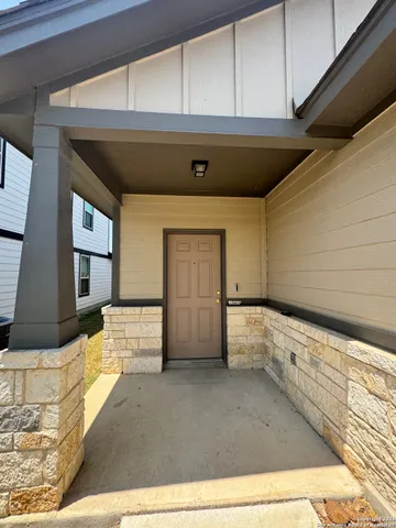 a view of a hallway to rooms and stairs