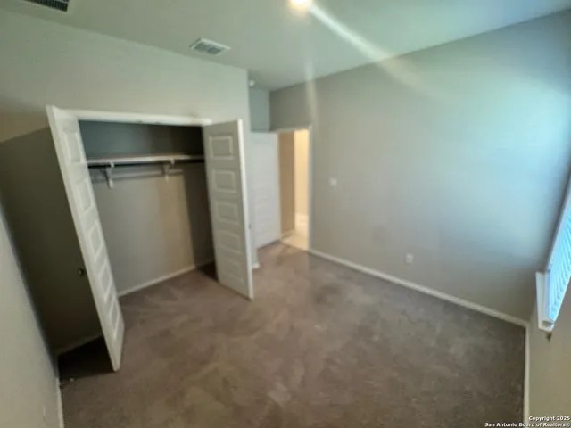 an empty room with closet and door