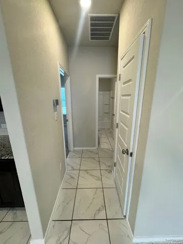 a bathroom with a granite countertop sink a mirror and vanity