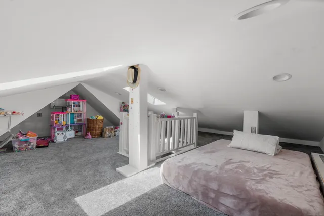 a bedroom with bed and a window