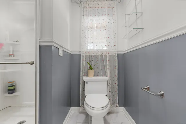 a white toilet sitting next to a bathroom sink