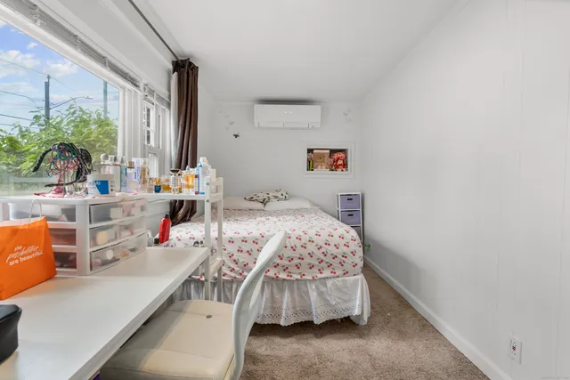 a bedroom with bed and a window