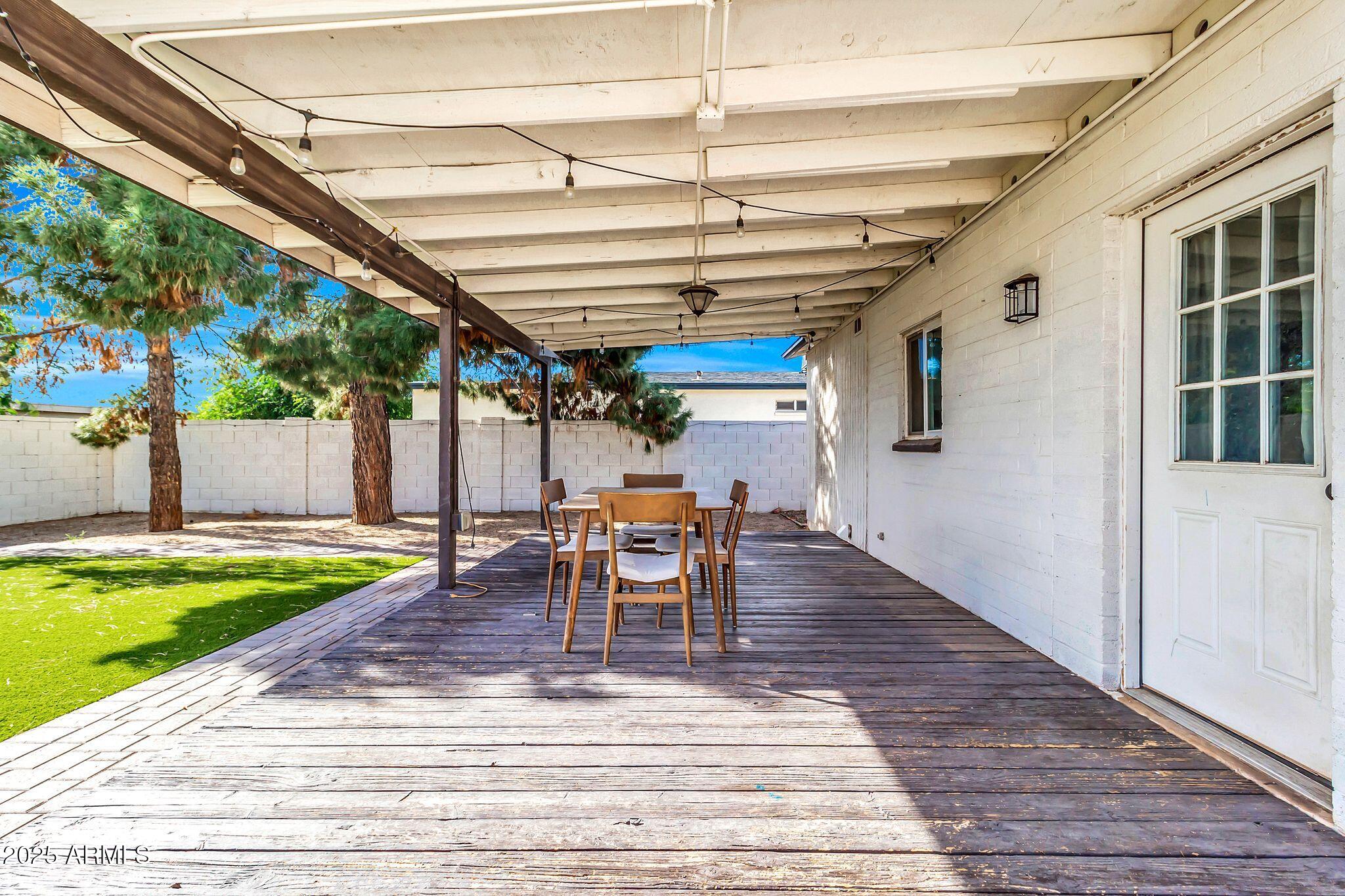 449 East Harmony Avenue Mesa, AZ 85204 - Photo 23 of 30 a view of a patio with a table and chairs