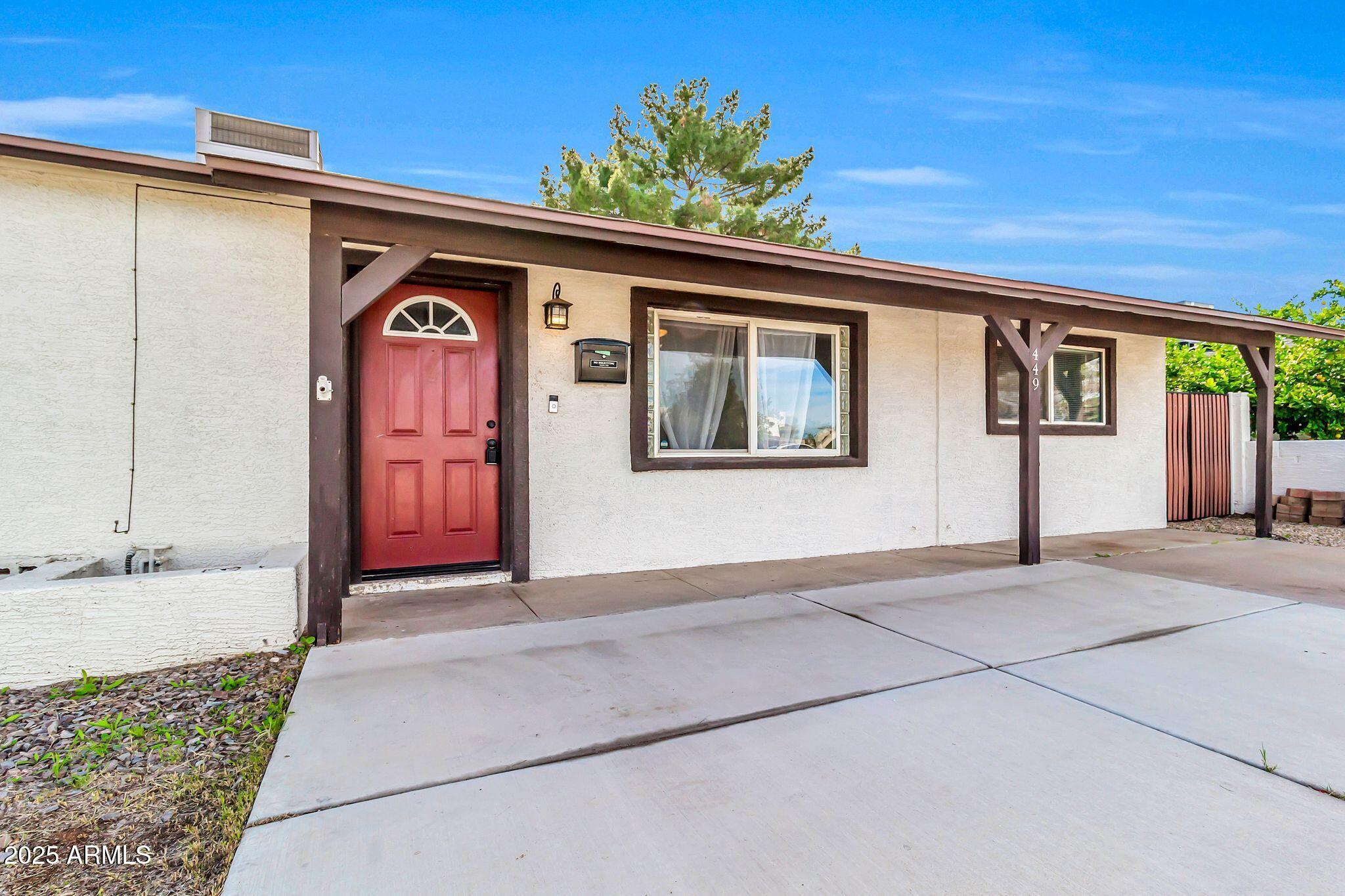 449 East Harmony Avenue Mesa, AZ 85204 - Photo 3 of 30 a front view of a house with a porch