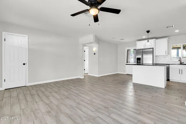 a view of a kitchen with a dishwasher cabinets and wooden floor