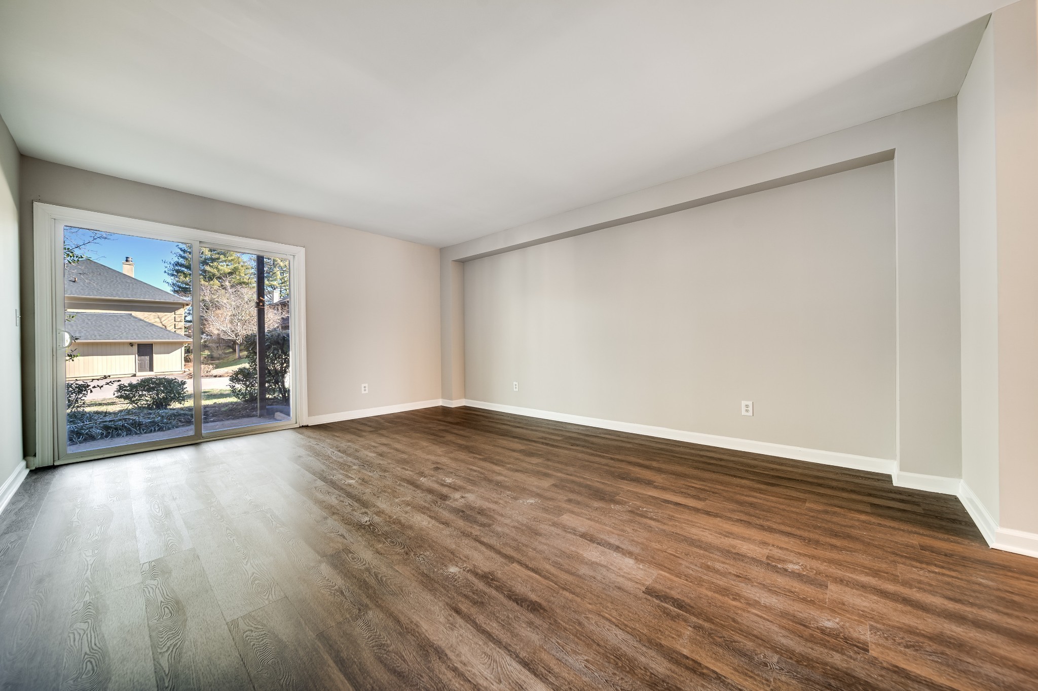 4487 Post Place, Unit 165 Nashville, TN 37205 - Photo 11 of 41 a view of an empty room with wooden floor and a window