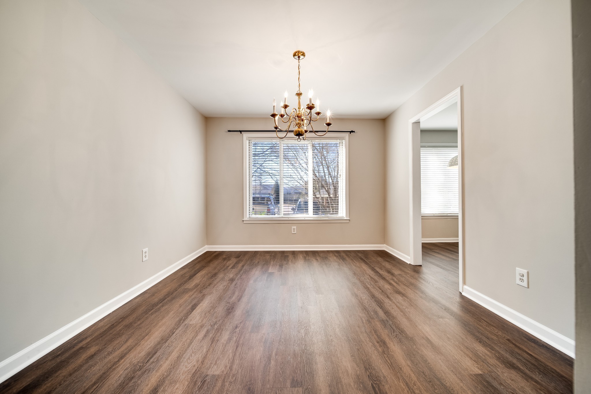 4487 Post Place, Unit 165 Nashville, TN 37205 - Photo 16 of 41 an empty room with wooden floor chandelier and windows