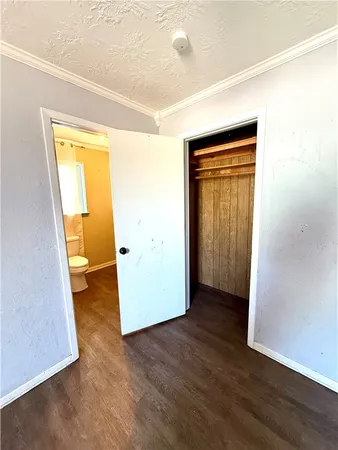 a view of a room with wooden floor and a window